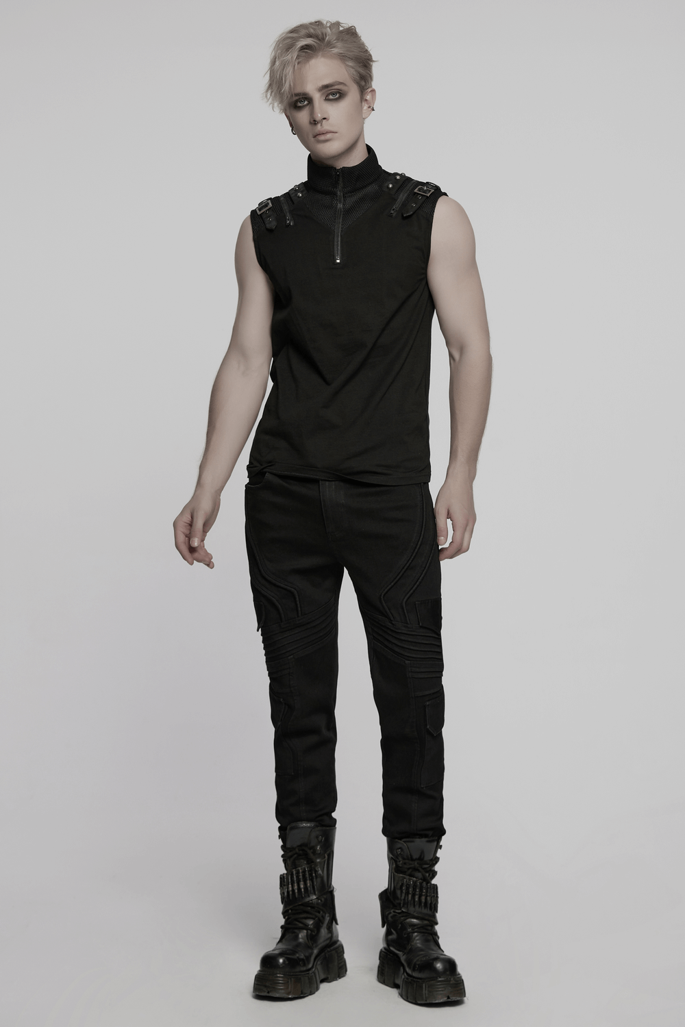 Stylish male model in slim fit black punk pants with cargo pockets and a sleeveless top, showcasing edgy fashion.