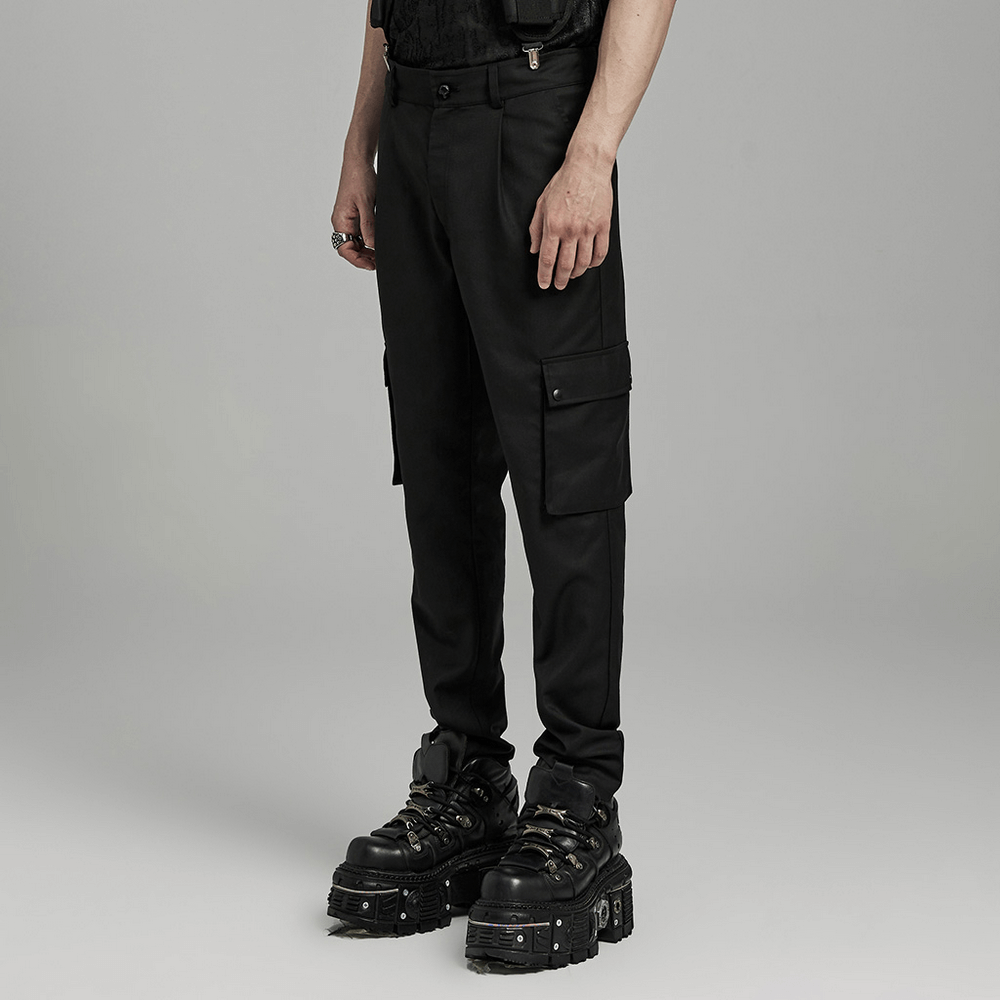 Black minimalist cargo trousers for men with side pockets, paired with chunky platform boots for a trendy look.