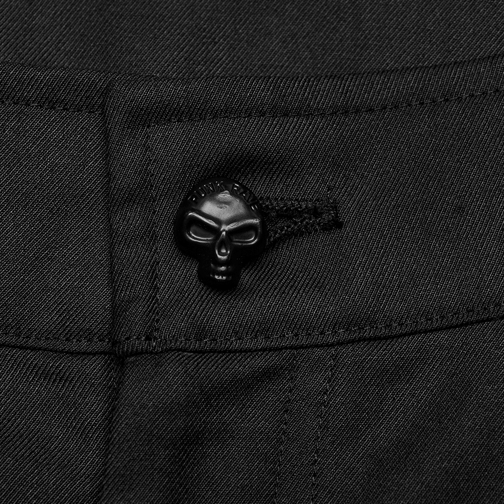 Close-up of black cargo trouser button featuring a skull design, showcasing unique minimalist style.