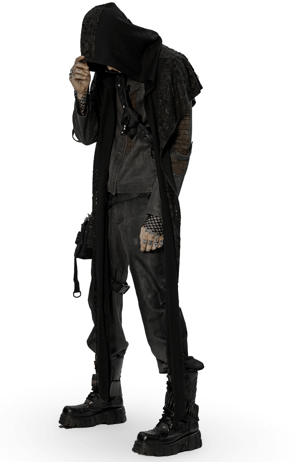 Male model in distressed knit hooded cape and long scarf, embodying edgy, post-apocalyptic style.