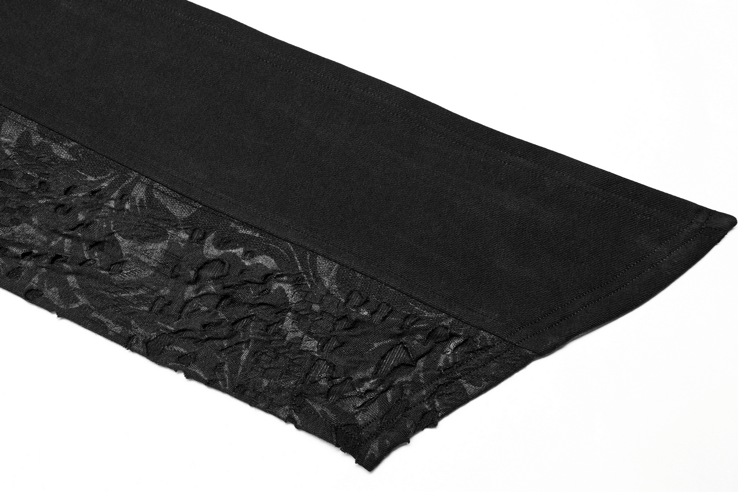 Close-up of the distressed knit fabric on a male deconstructed hooded cape, featuring a textured black design.