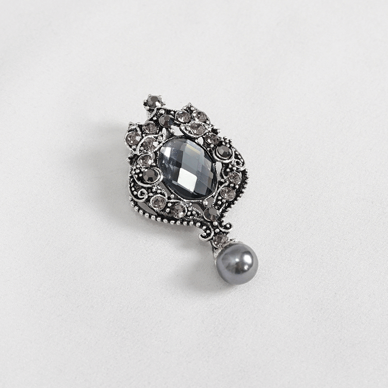 Vintage crystal brooch with black gemstones and pearl accent, perfect for gothic fashion accessories.
