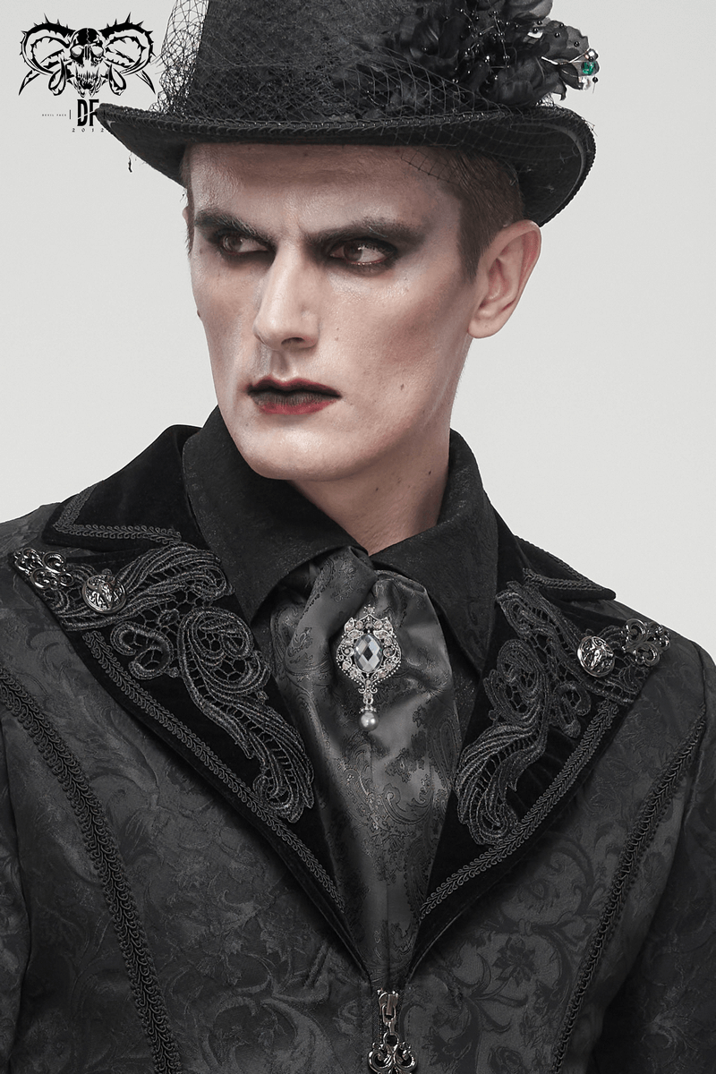 Male model in gothic attire featuring a black floral printed tie with crystal brooch and a stylish top hat.