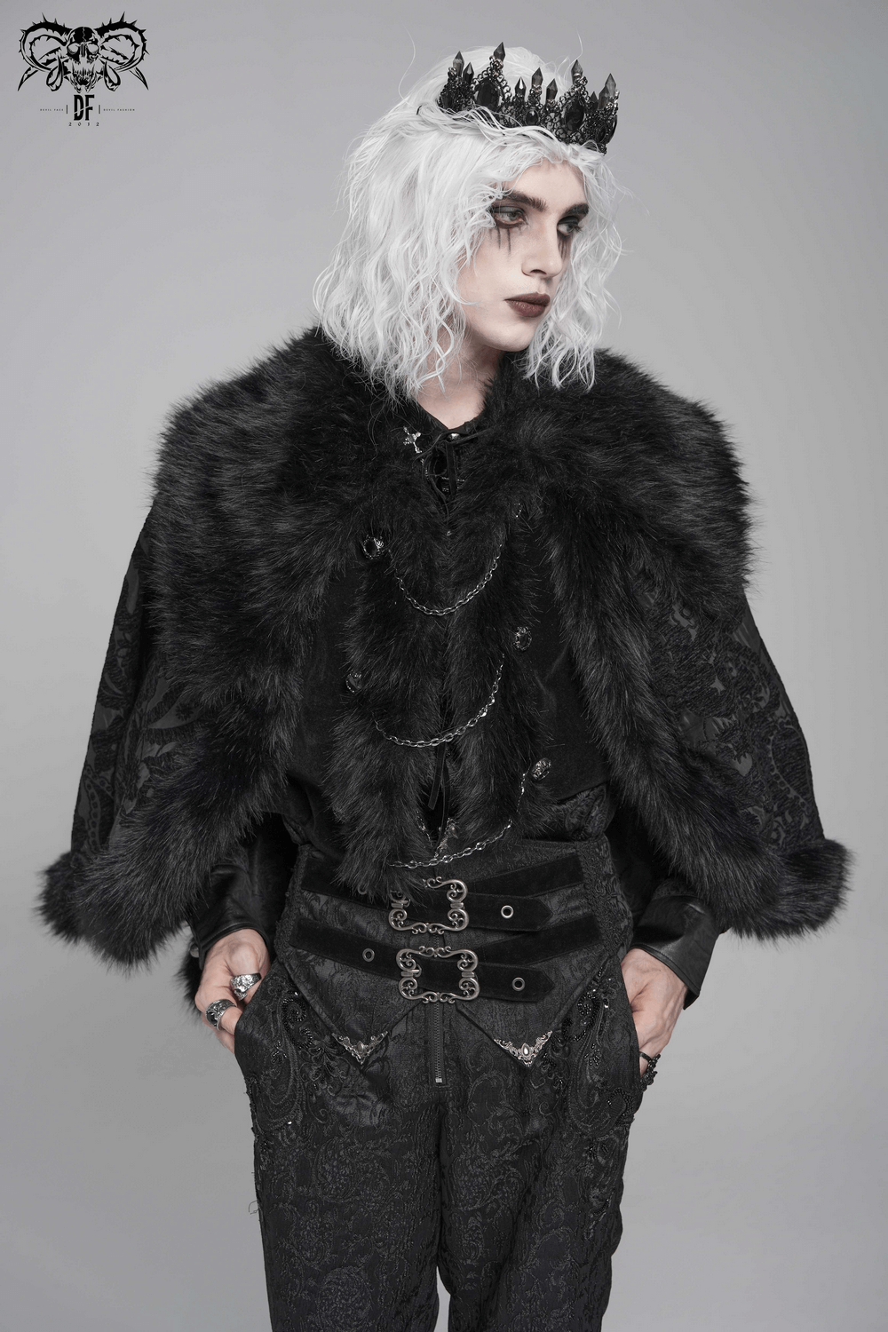 Male Gothic Cape with Faux Fur Collar and Hem Trim worn by model with light hair and crown, showcasing dark brocade and dramatic style.