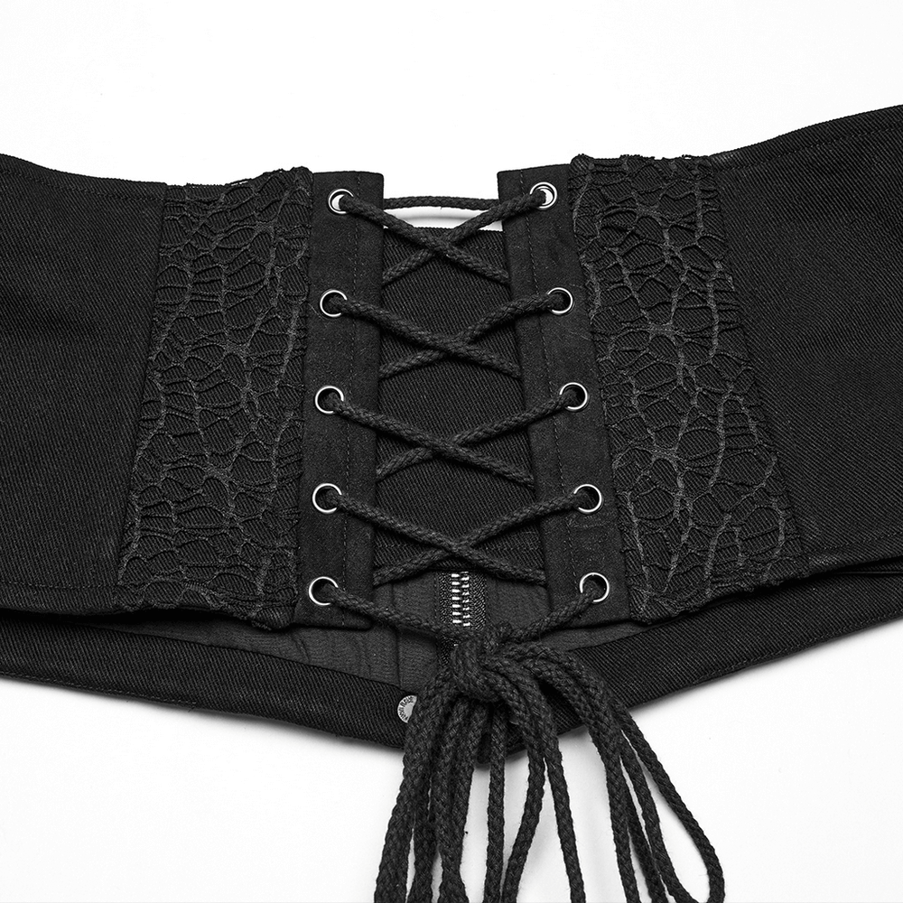Close-up of a black male gothic corset belt featuring lace-up back and zipper front, adorned with rivets.