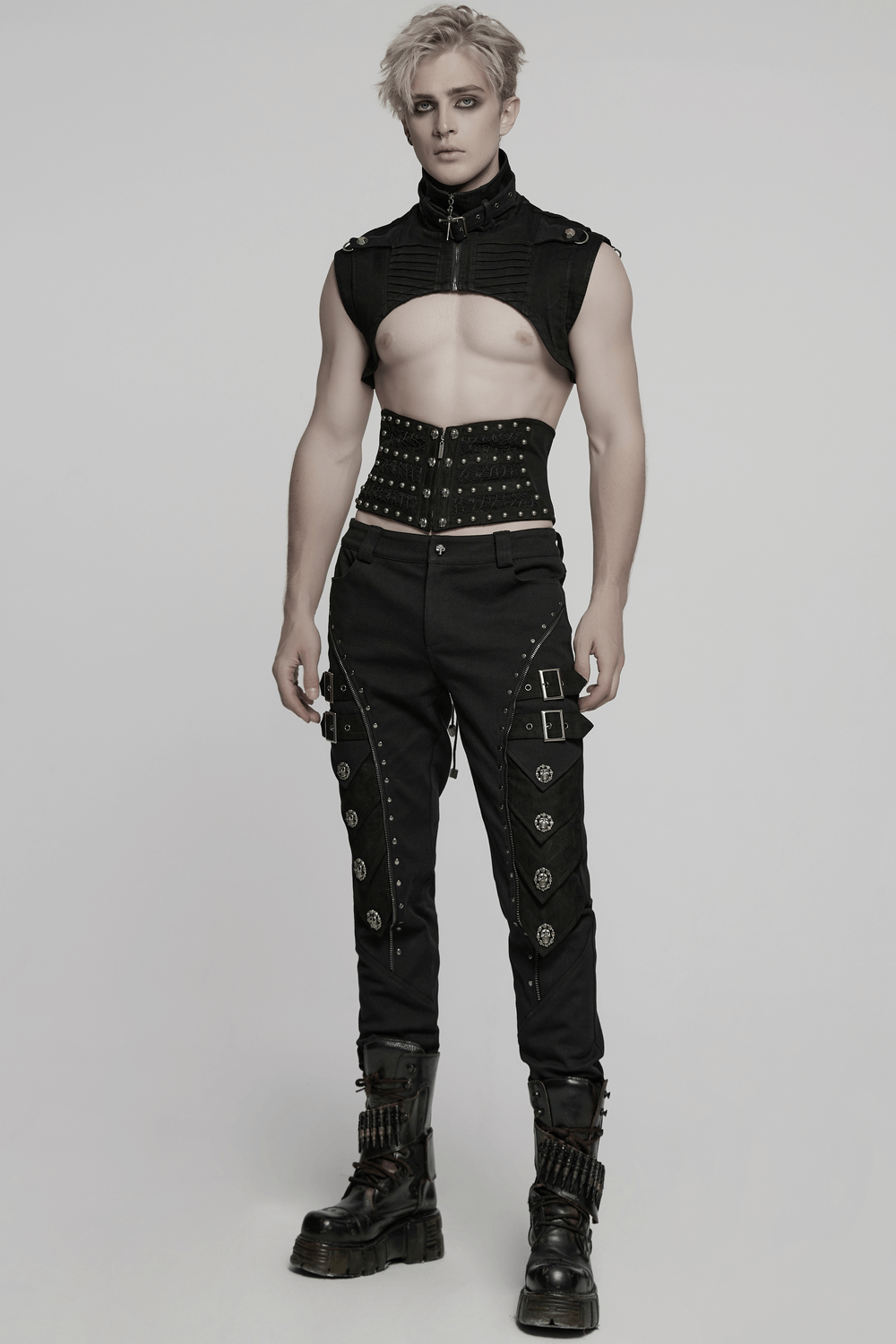 Male model in a gothic punk corset belt with rivets, styled with edgy black pants and boots.