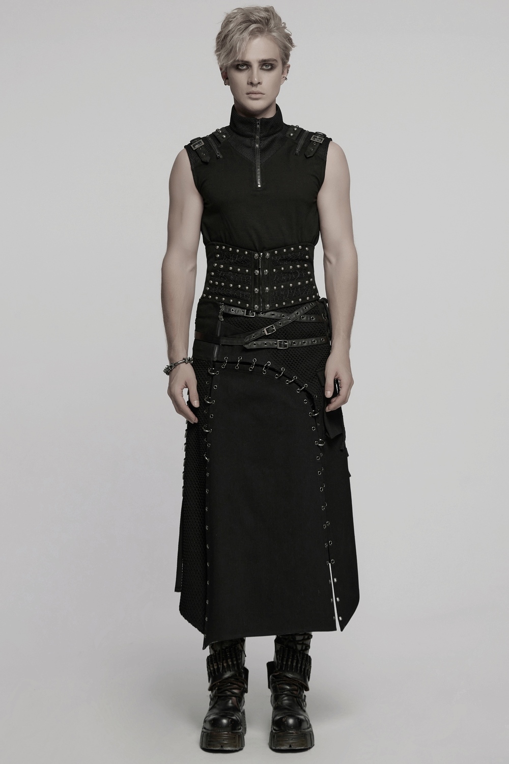 Male model wearing a gothic corset belt with rivets and a stylish layered skirt, showcasing a punk fashion statement.