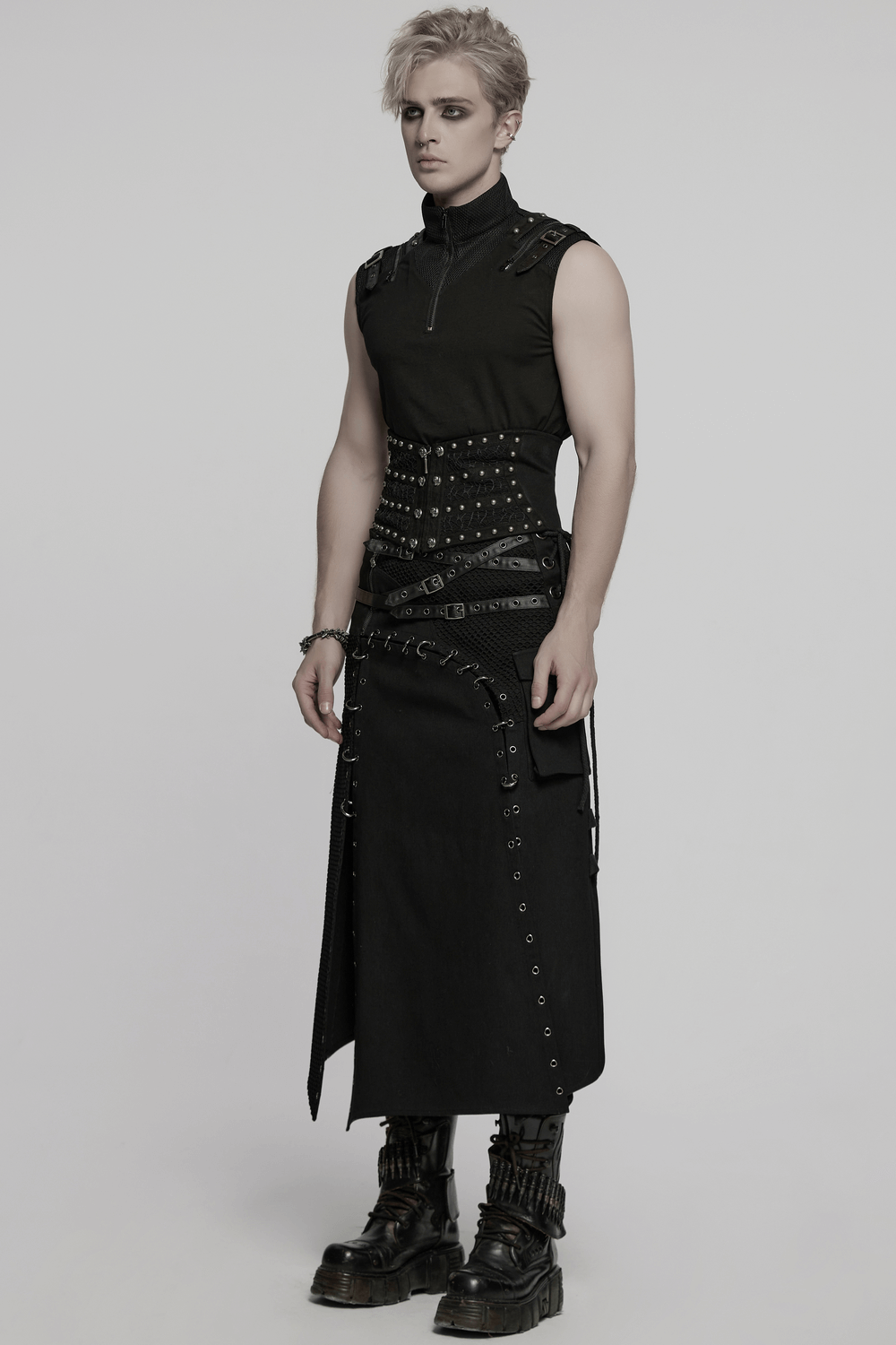 Male model in a gothic punk corset belt with rivets and lace-up details, paired with a stylish black outfit.