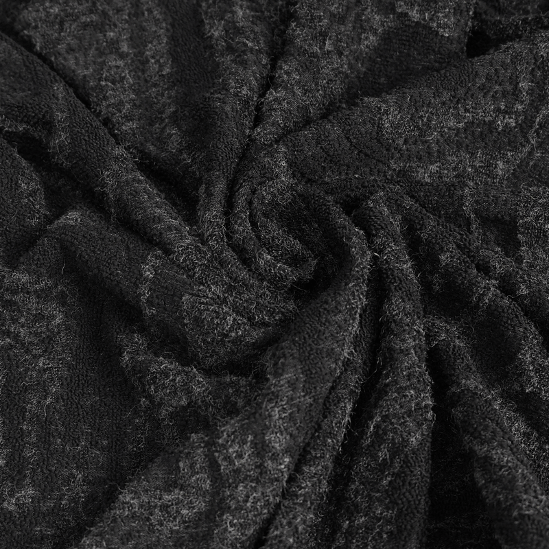 Close-up of textured black fabric showcasing the soft, gothic-inspired material for men's hooded coat.