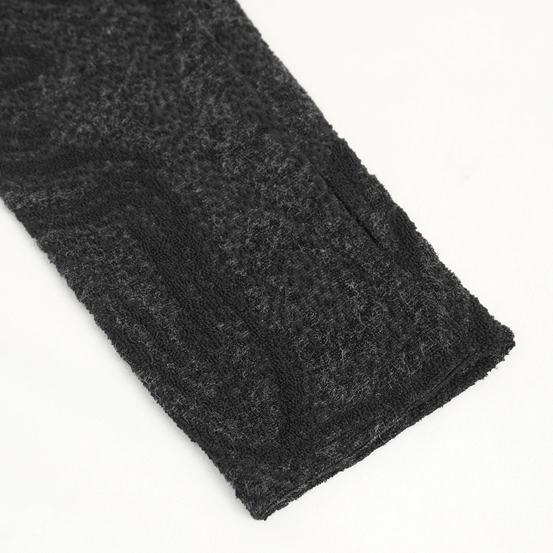 Close-up of the sleeve of a male gothic irregular hooded coat, showcasing its textured black fabric.