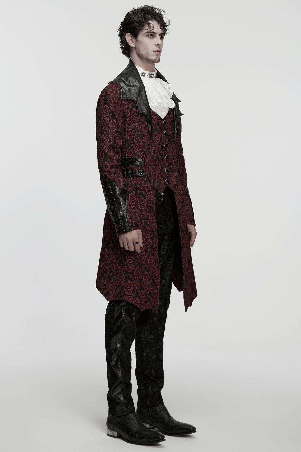 Male Gothic Jacquard Long Coat with Leather Details worn by a model, featuring bat collar and gemstone buttons.