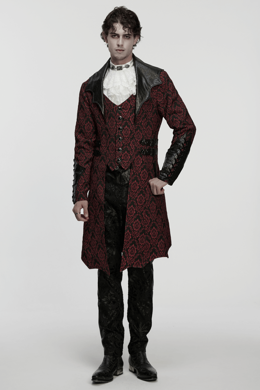 Male Gothic Jacquard Long Coat with Leather Details worn by a model, showcasing its dramatic bat collar and gemstone buttons.
