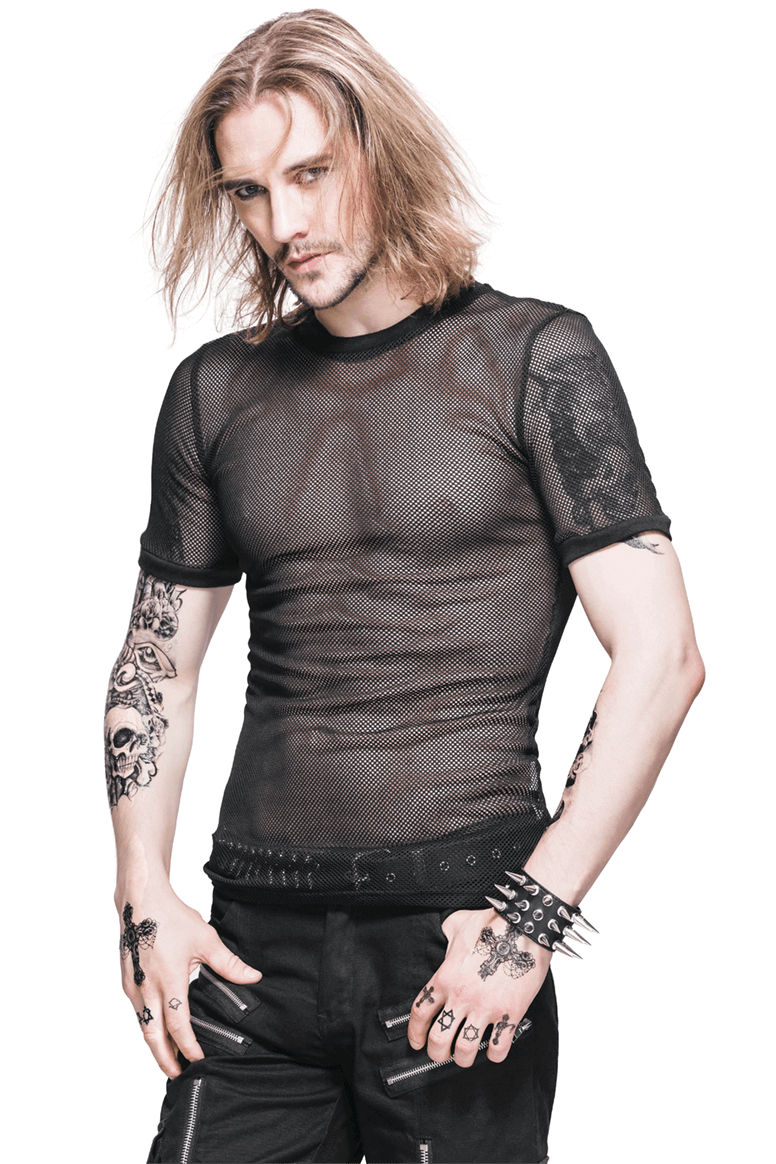 Stylish male model wearing a black sheer mesh Gothic T-shirt, showcasing tattoos and a fitted look.