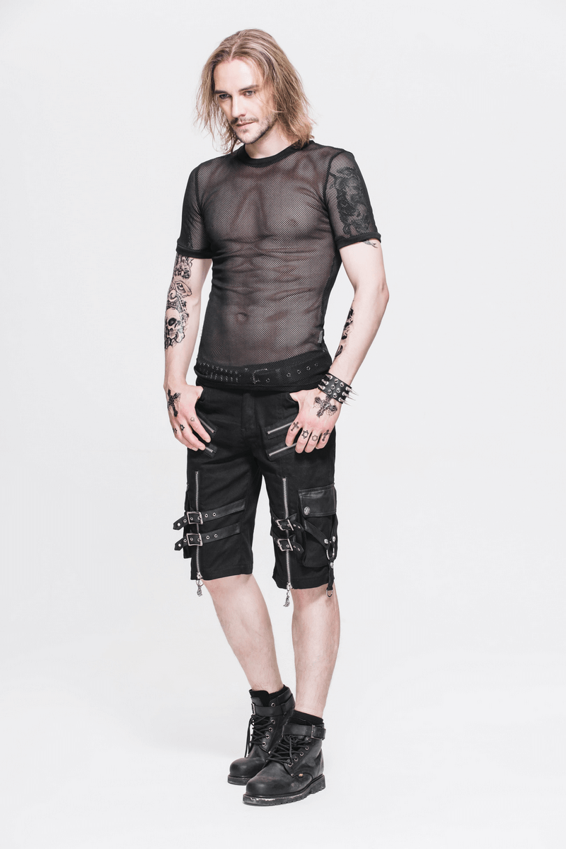 Stylish male model in a sheer black gothic mesh t-shirt paired with edgy shorts and boots, showcasing modern gothic fashion.