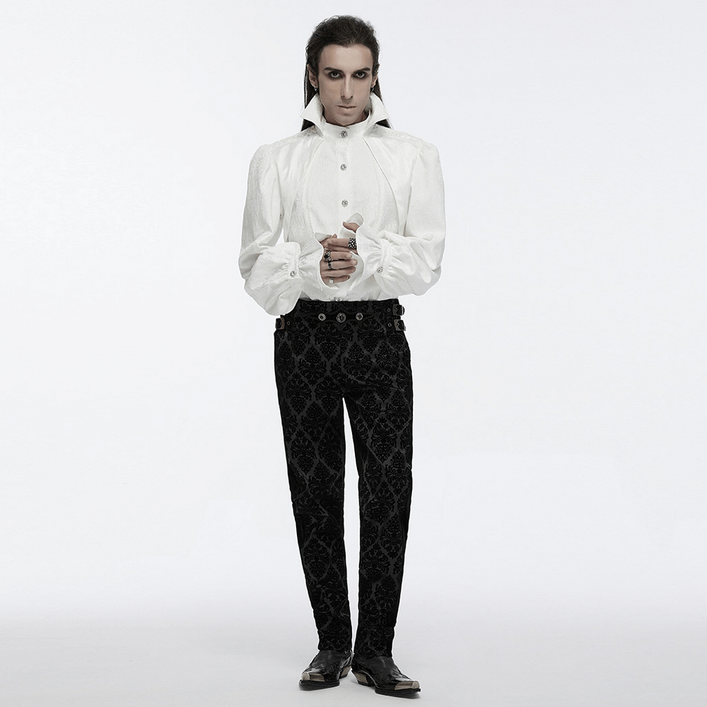 Male model in a gothic white shirt with bubble sleeves and elegant black pants, showcasing a dramatic palace-inspired look.