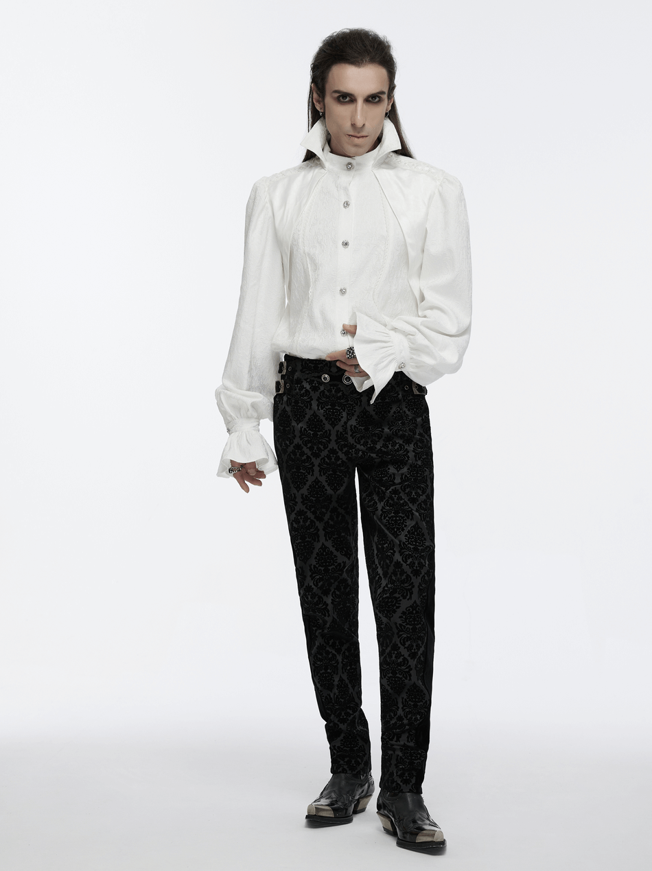 Male model in a gothic stand collar shirt with bubble sleeves and velvet black pants, showcasing a dramatic silhouette.