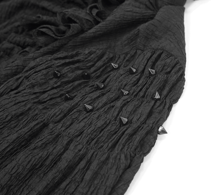Close-up of black vintage gothic shirt showcasing textured fabric and decorative spikes.