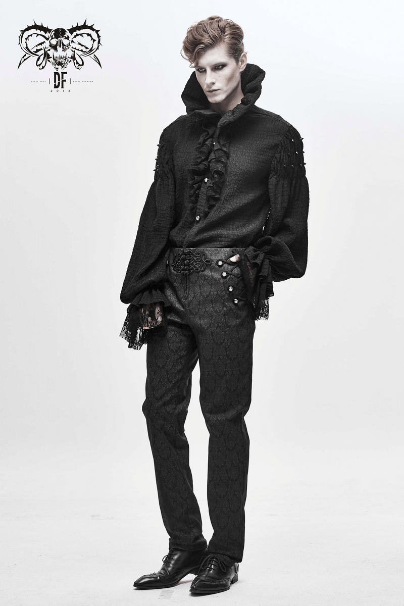 Elegant male model wearing a gothic style black long sleeve shirt with ruffles and vintage black trousers.