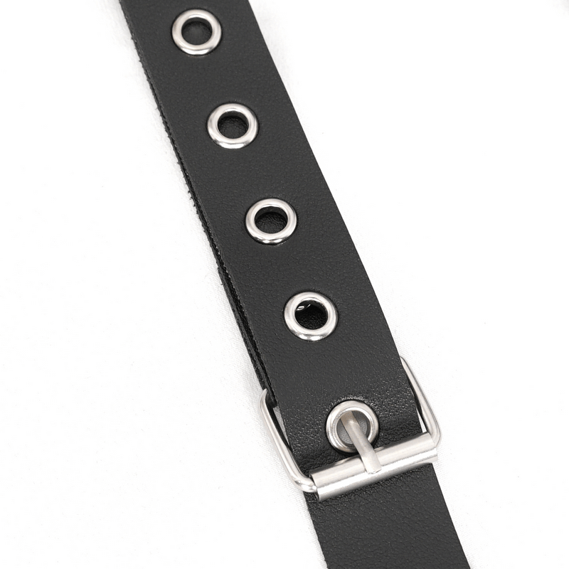 Close-up of a black PU leather strap with metallic grommets and buckle, perfect for punk style body harnesses.