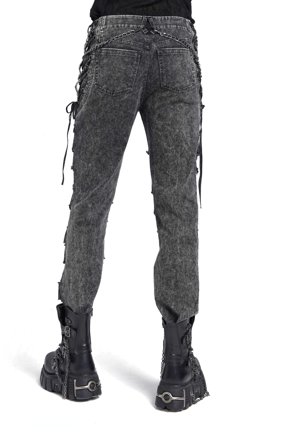Male ripped jeans with chains, shredded legs, and lace-up sides, styled with edgy platform boots.