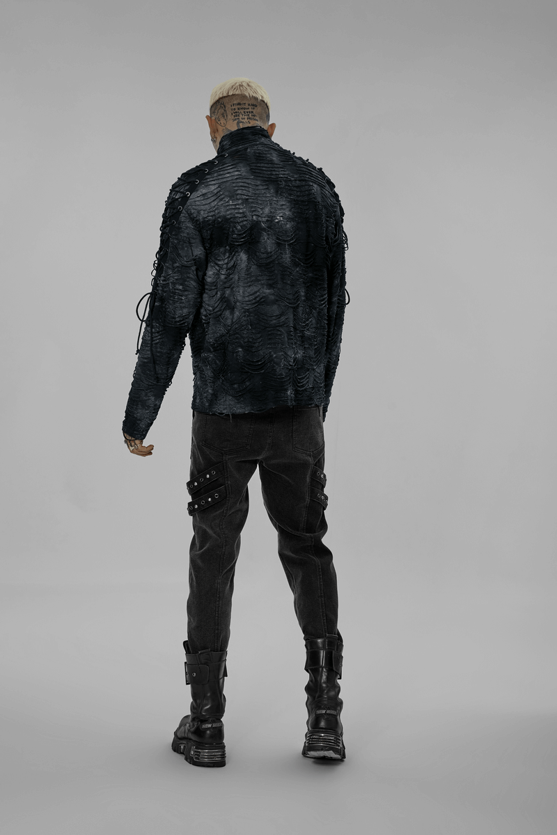 Back view of a male model in a textured black jacket and cargo pants, showcasing a bold, post-apocalyptic fashion style.