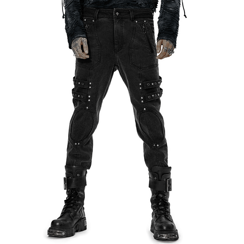 Male rugged denim cargo pants with edgy knee patches and decorative loops, styled in post-apocalyptic fashion.