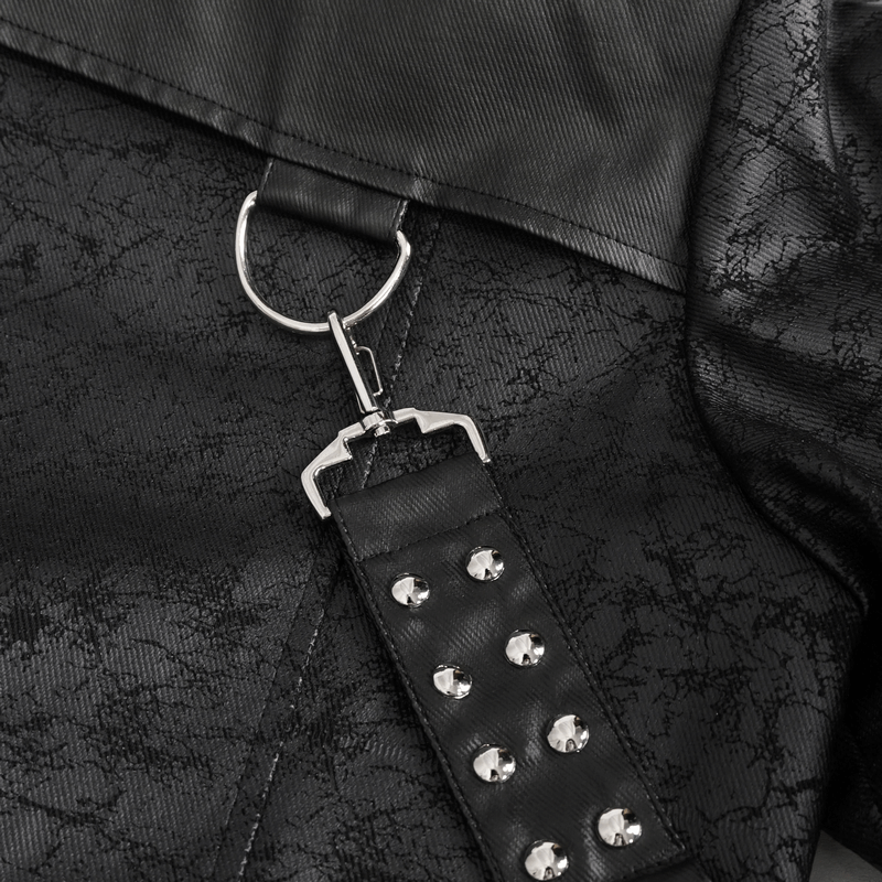 Close-up of detachable crossbody strap with silver studs on a stylish black coat, highlighting its edgy design.