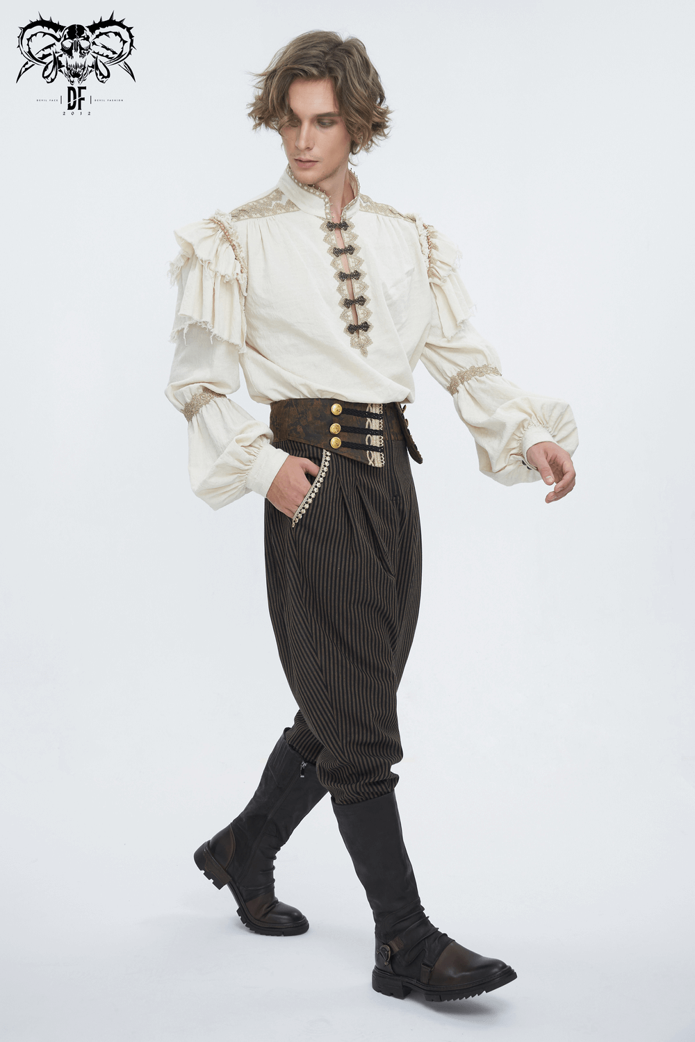 Stylish male model wearing ruffled white shirt and striped high-waist trousers with buttons, showcasing modern fashion.
