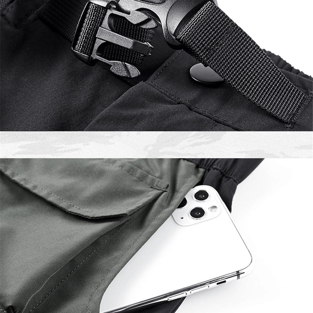 Close-up of tactical shorts showing adjustable waistband and phone tucked in multi-pocket design.