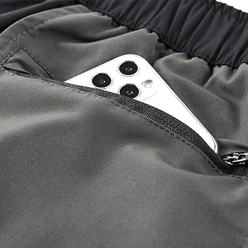 Close-up of gray tactical shorts pocket with a smartphone nestled inside for style and convenience.