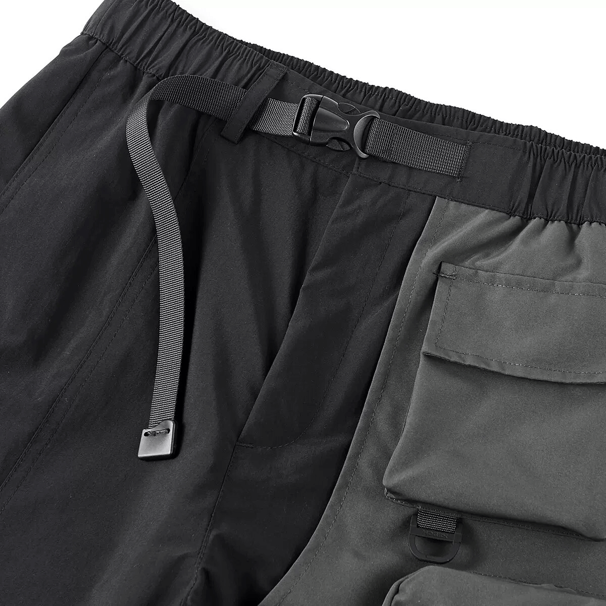 Close-up of male tactical multi-pocket shorts showcasing adjustable waistband and diverse pockets for functionality.