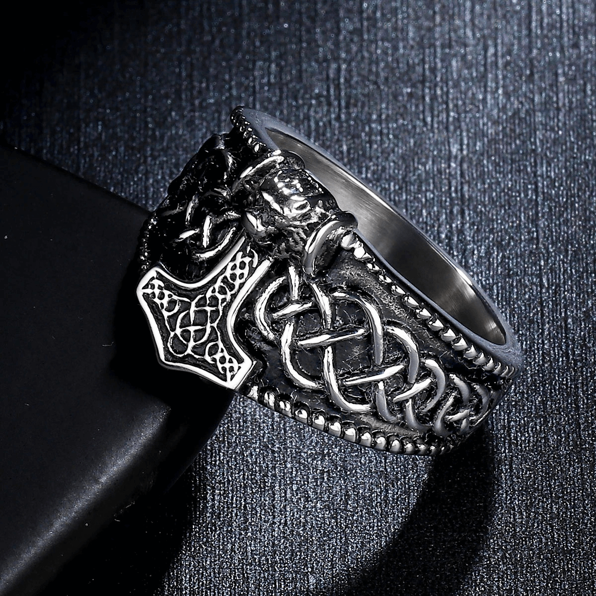 Male Thor's Hammer Celtic ring on a black surface, showcasing vintage punk style and intricate design in stainless steel.