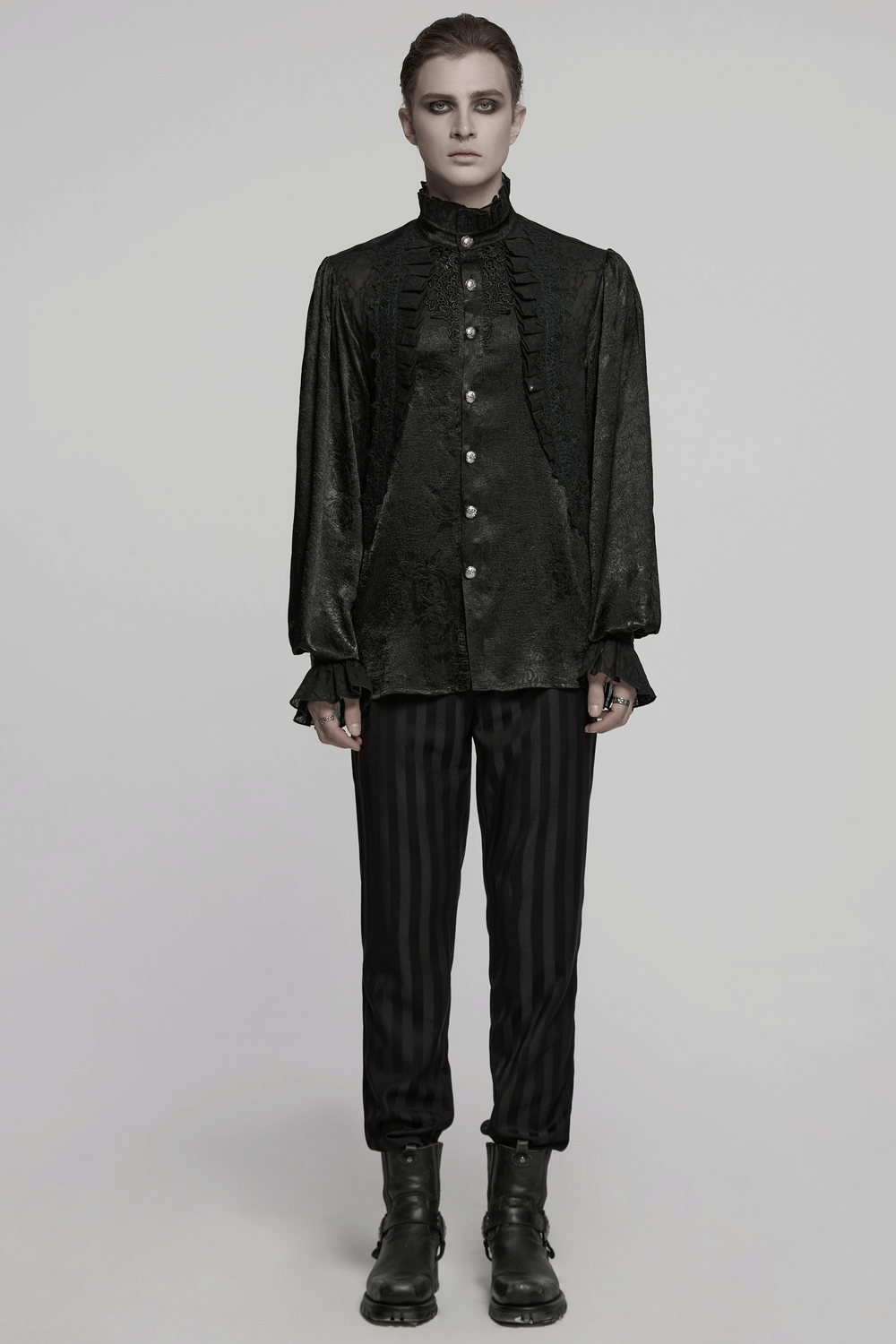 Male Victorian black shirt with lace cuffs and engraved buttons, paired with black striped pants for a gothic look.