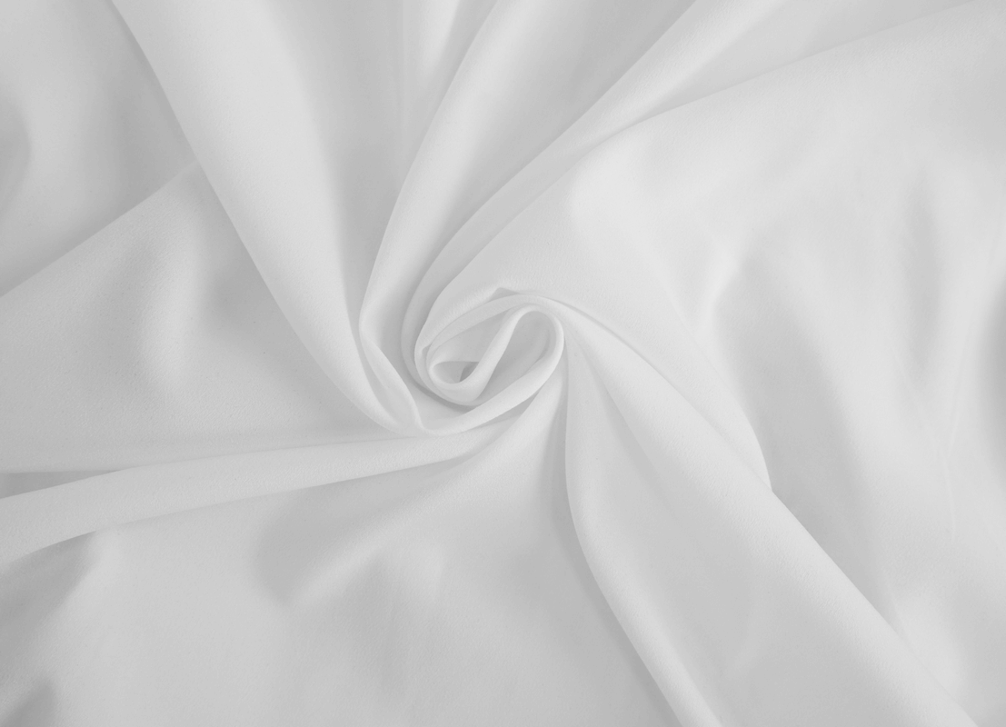 Soft white fabric swirling in a spiral, perfect for vintage gothic shirts and elegant clothing.