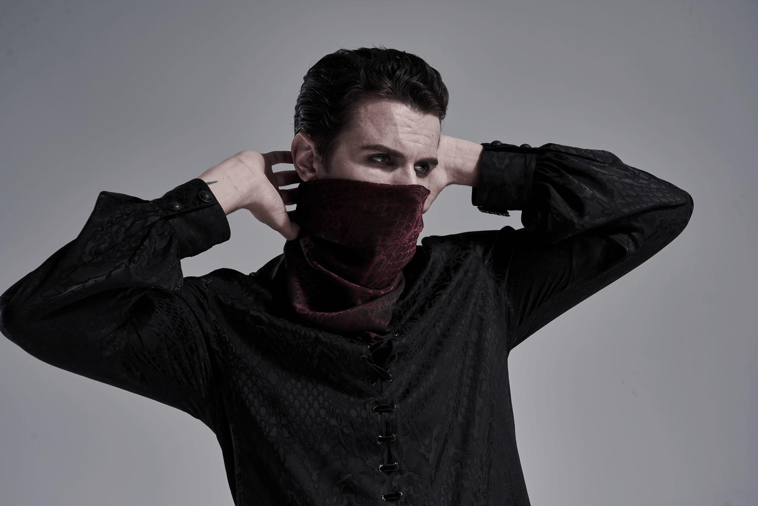 Model wearing a male wine-red gothic jacquard triangular bandana as a face mask, channeling a vampire aesthetic.