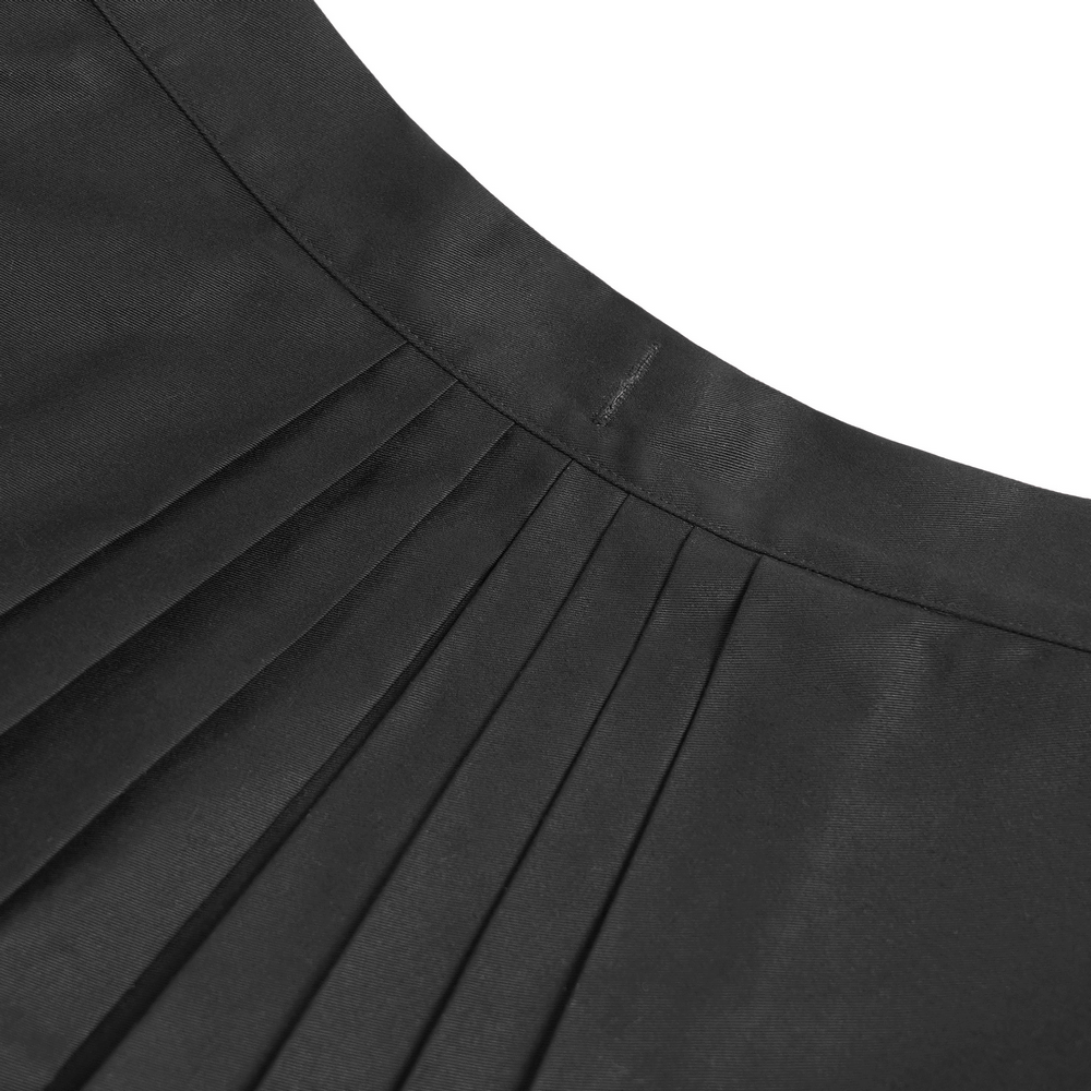 Close-up of the pleated top of a black maxi skirt featuring stylish pentagram straps and grommet details.