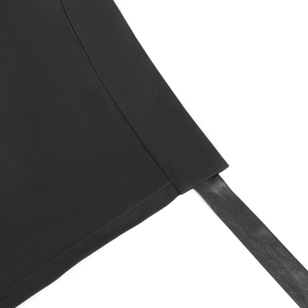 Close-up of black maxi skirt featuring pentagram straps and grommet details, showcasing stylish edge.