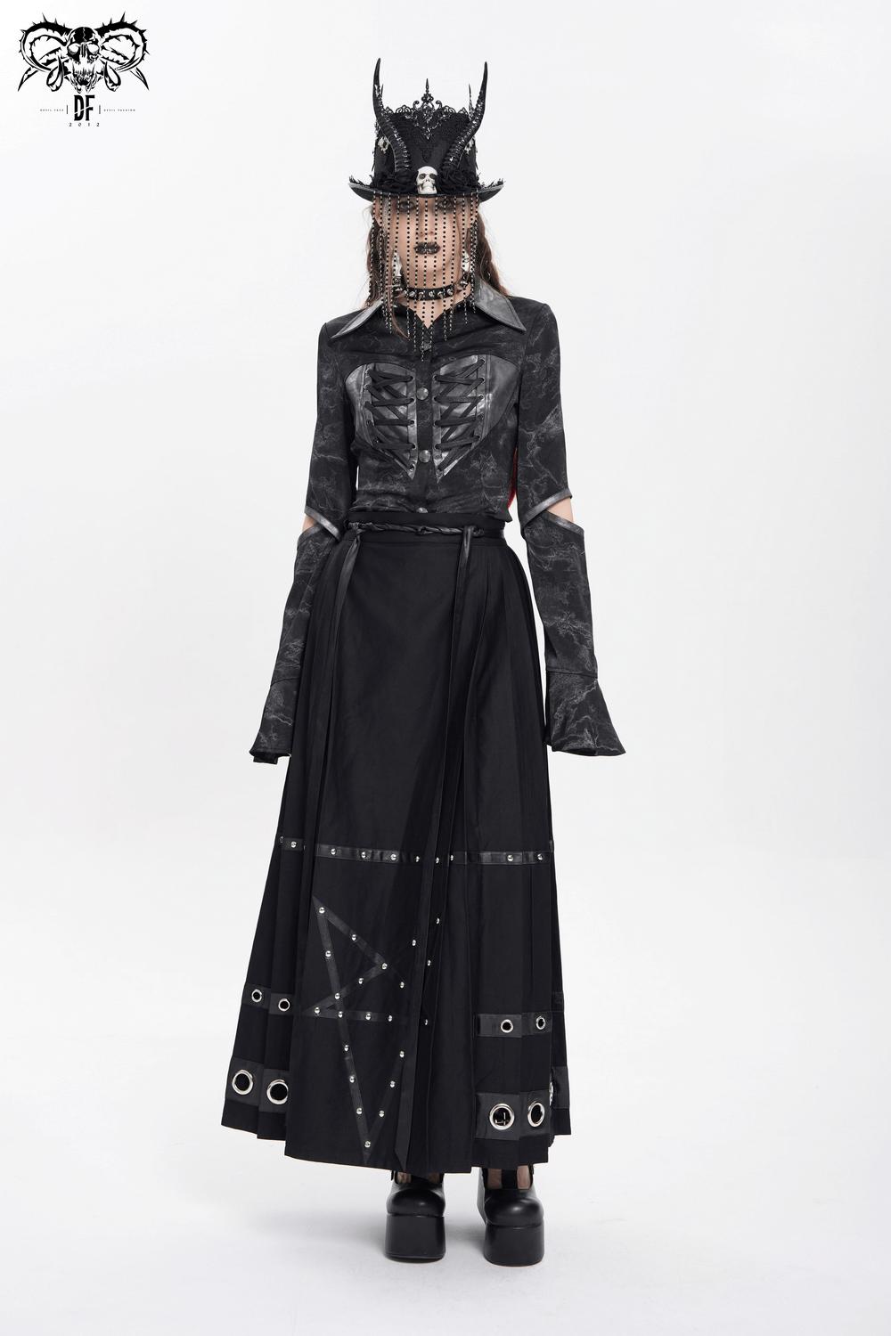 Gothic maxi skirt with pentagram straps and grommet details, worn with a stylish black shirt and accessories.