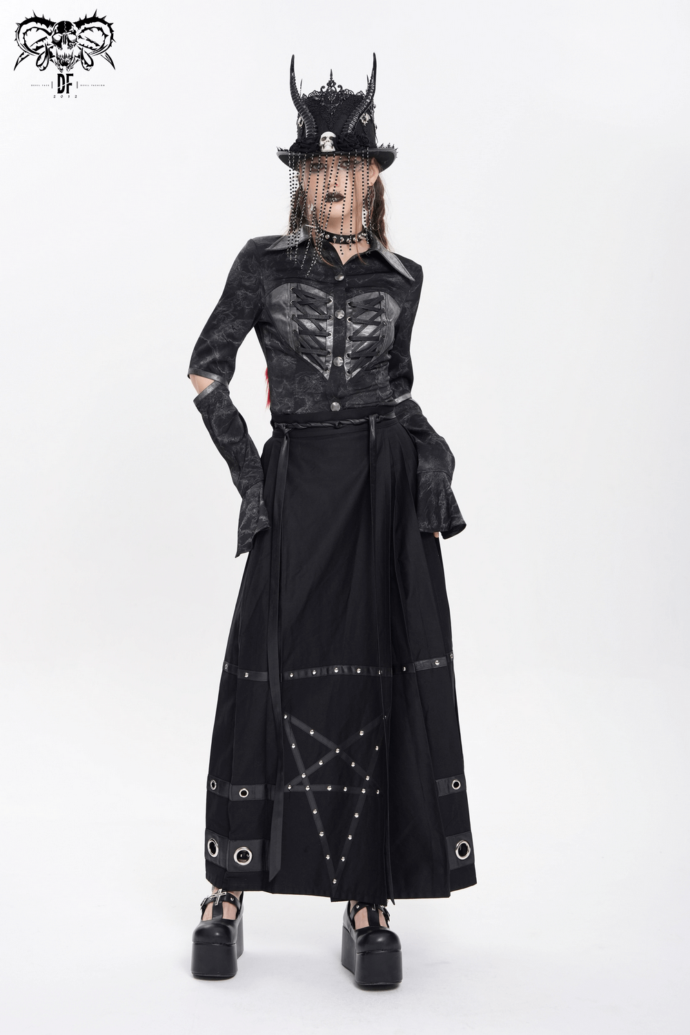 Maxi skirt featuring pentagram straps and grommet details, paired with a stylish gothic top and black accessories.