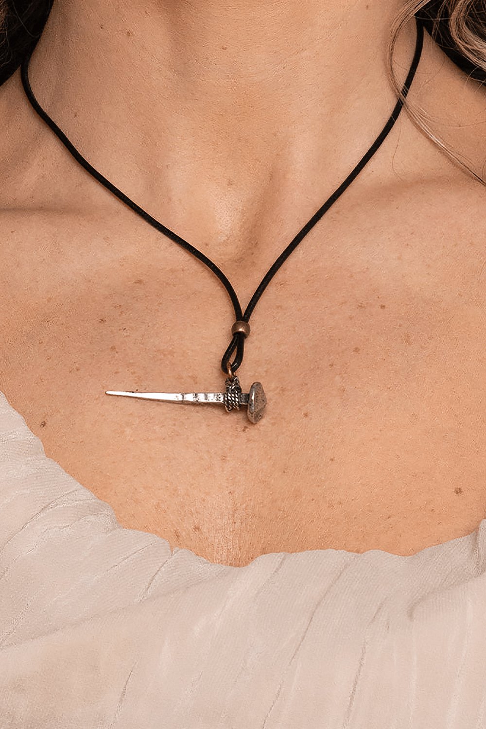 Medieval Nail Talisman Necklace with Norse Bind Rune worn on a black cord, showcasing its unique Viking design.