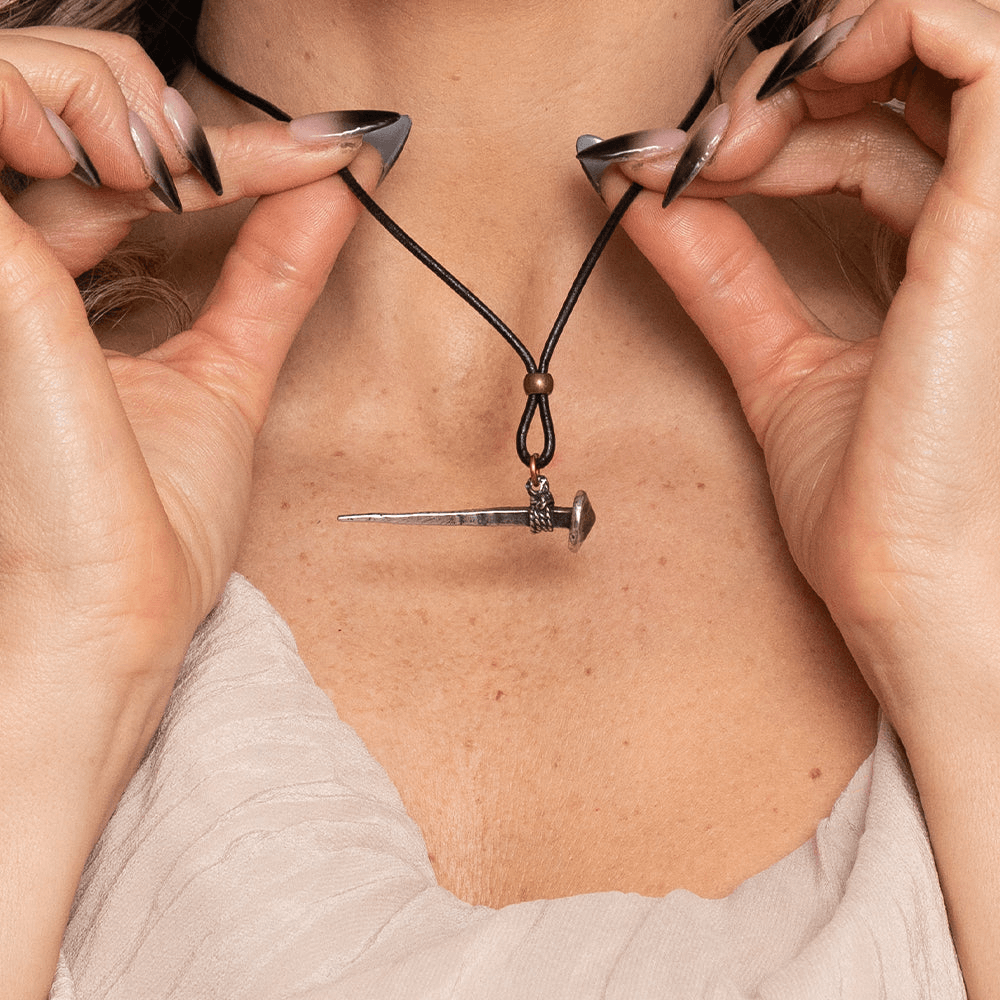 Medieval Nail Talisman Necklace with Norse Bind Rune displayed on a model's neck, showcasing its unique design.