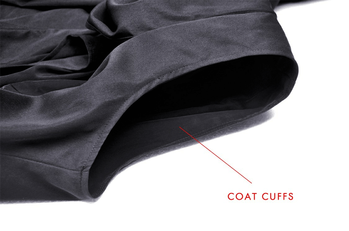 Close-up of the coat cuffs on a black hooded cape cloak, showcasing sleek design and elegant fabric.