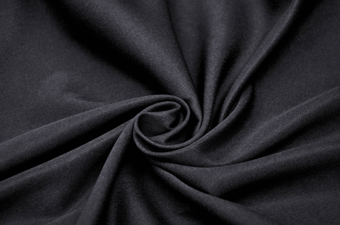 Close-up of smooth black polyester fabric, perfect for hooded capes and cloaks for Halloween and cosplay.
