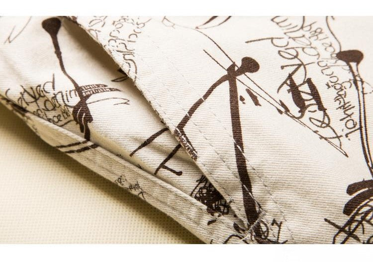 Close-up of cotton fabric with artistic printed design, showcasing stitch details and textures.