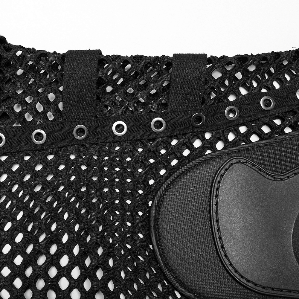 Close-up of black mesh fabric with eyelets and a patch, showcasing edgy cyberpunk style.