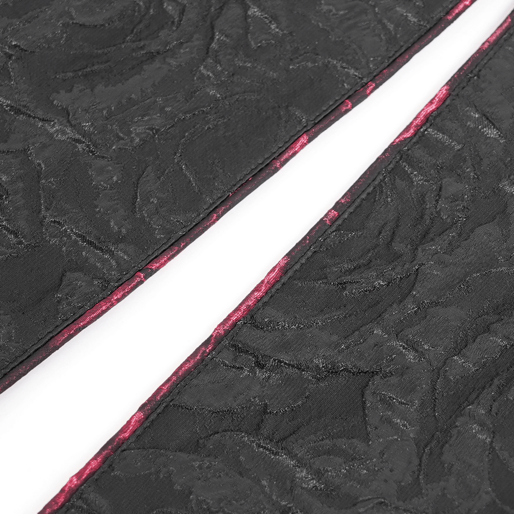 Close-up of the dark rose brocade texture on a gothic vest with contrasting red detailing.