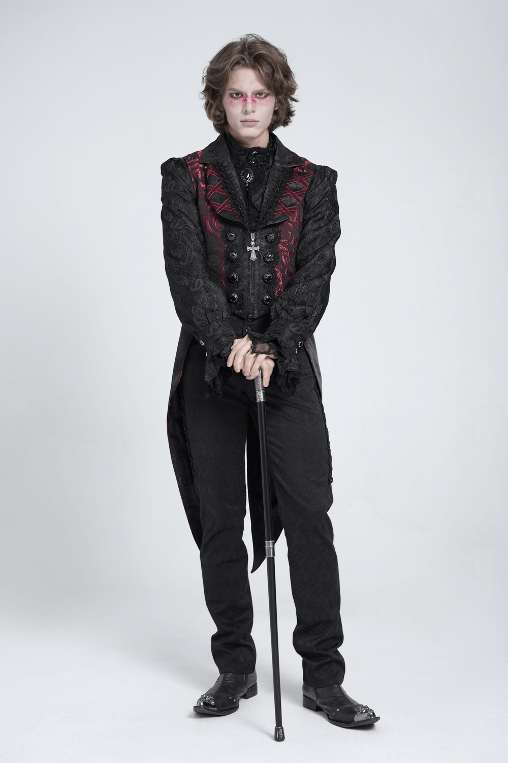 Gothic men’s vest in dark rose brocade with cross details, styled with dramatic tailcoat and sleek black trousers.