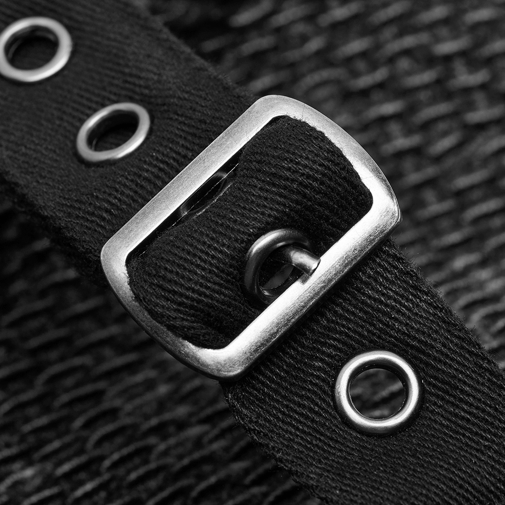 close-up of a black strap with a silver buckle and metal eyelets, showcasing gothic fashion details.