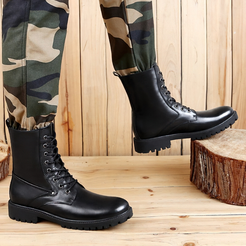 Black leather moto boots for men, stylish and genuine, perfect for outdoor and casual wear with flexible soles, shown on wooden floor.