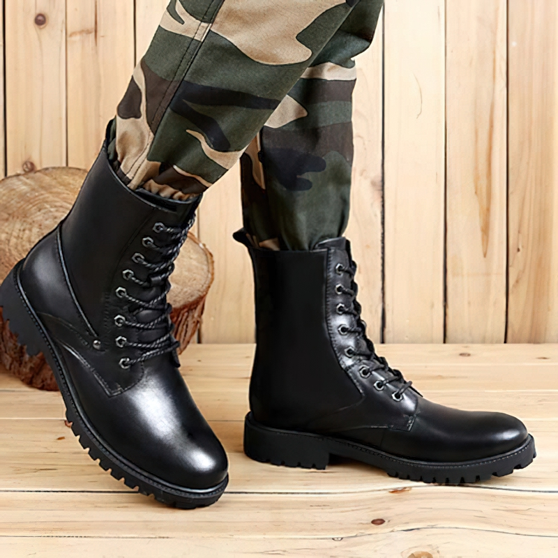 Black genuine leather men's moto boots mid-calf biker style with flexible soles, paired with camouflage pants.